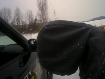 Deputy Jake Thorne of the Macomb County Sheriff's Office in Michigan helps a despondent man on the side of the road.