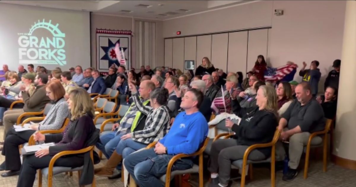 Residents cheer after the Grand Forks, North Dakota, City Council voted to shut down a Chinese corn mill project on Monday.