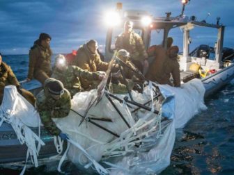 This screen shot shows Navy sailors recovering the remnants of the Chinese spy balloon off the coast of Myrtle Beach, South Carolina on February 5, 2023.