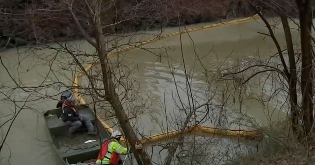 A clean up crew works in the Otter Creek, a tributary of the Delaware River, in Pennsylvania after chemicals leaked into the water on Friday.