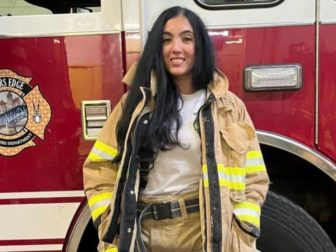 Gisele Barreto Fetterman, the wife of Pennsylvania Sen. John Fetterman, poses next to a fire truck.