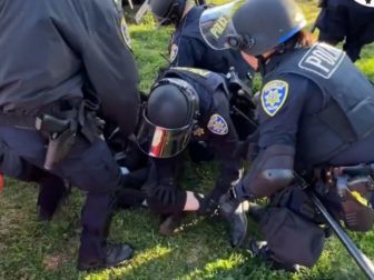 Police are seen stopping individuals that were trying to block the entrance to Charlie Kirk's speech in California.