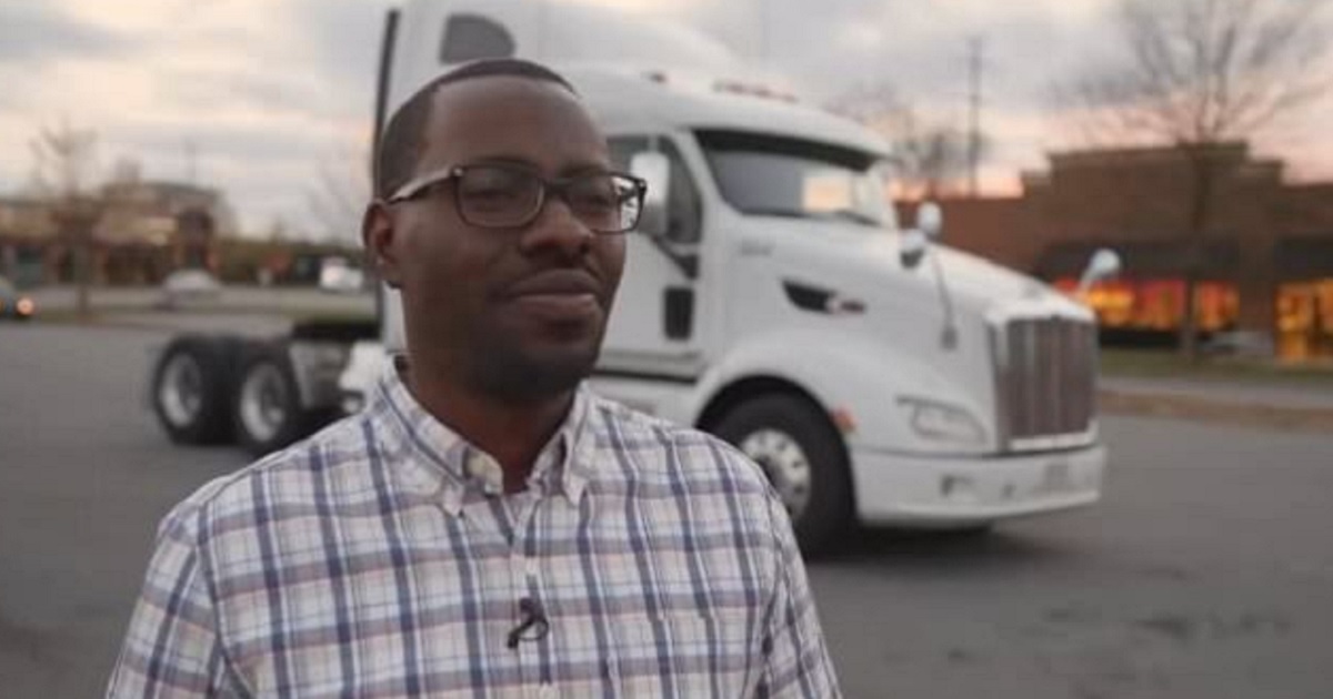 Jerry Johnson, a North Carolina resident and owner of a small trucking company, stands with a semi in the background.