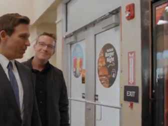 Florida Gov. Ron DeSantis looks over the beer selection at a convenience store with Benny Johnson.