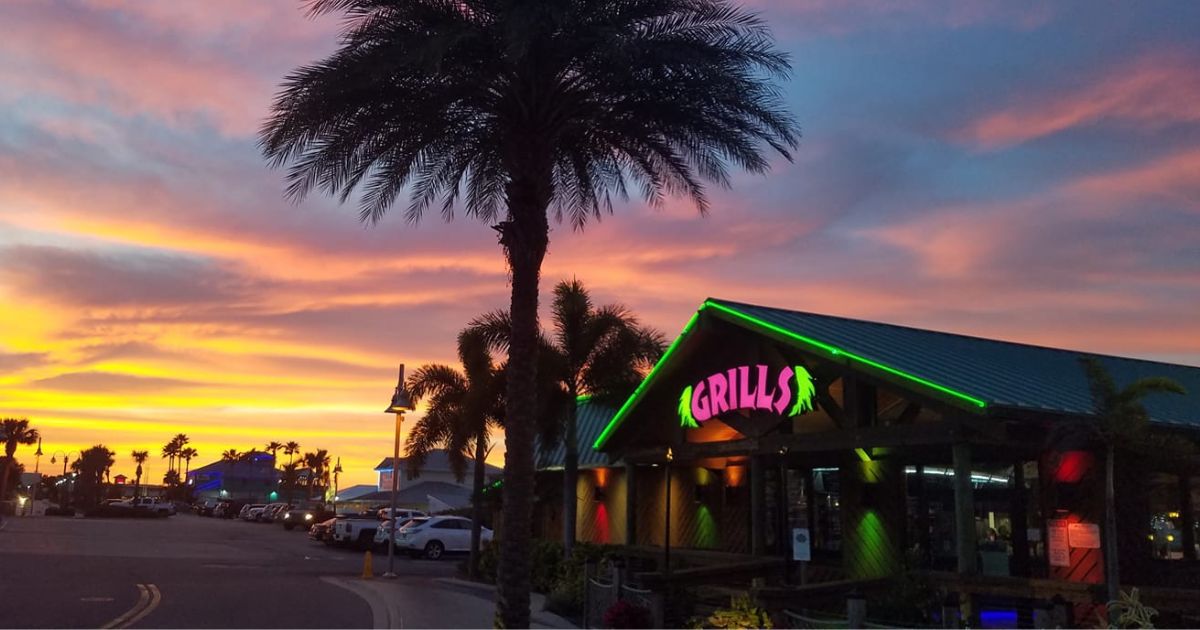 A sunset is seen at Grills Seafood Deck and Tiki Bar is seen in Port Canaveral, Florida, in 2021.