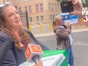 Arizona state Rep. Liz Harris, a Republican, carries belongings in a box from her office to a car after the state House voted to expel her on Wednesday.