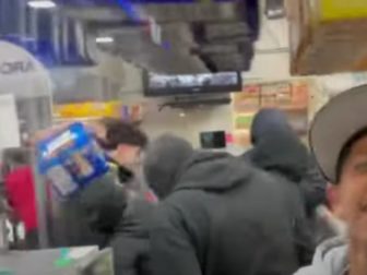 People are seen looting in a convenience store in California.