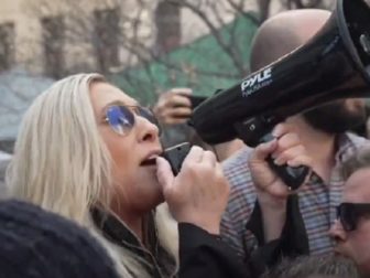 U.S. Rep. Marjorie Taylor Greene holds a bullhorn as she a protest in Manhattan on Tuesday against the arrest of former President Donald Trump.