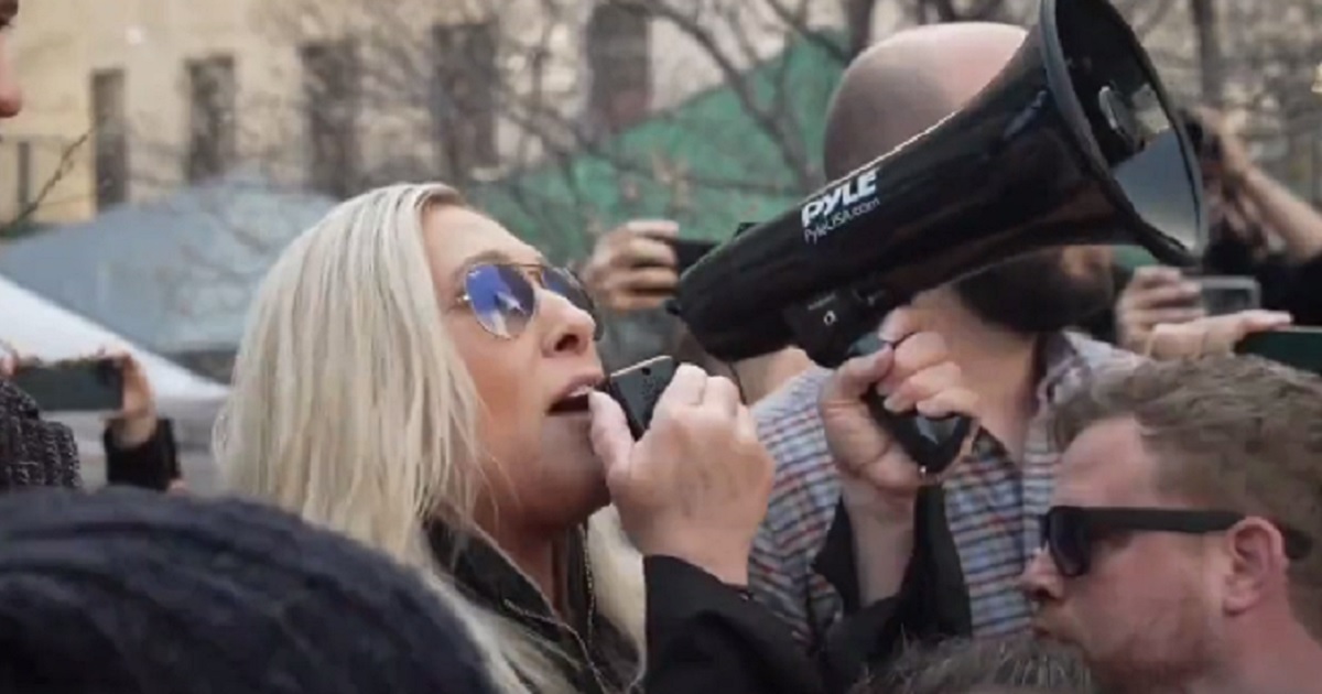 U.S. Rep. Marjorie Taylor Greene holds a bullhorn as she a protest in Manhattan on Tuesday against the arrest of former President Donald Trump.