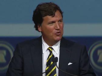 Tucker Carlson delivers the keynote address at The Heritage Foundation's 50th-anniversary gala on Friday at National Harbor, Maryland.