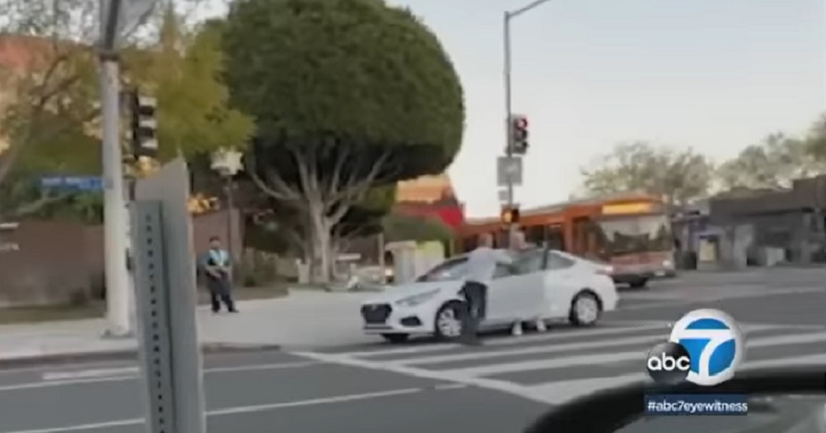 A fight begins on the street in front of two West Hollywood "security ambassadors."