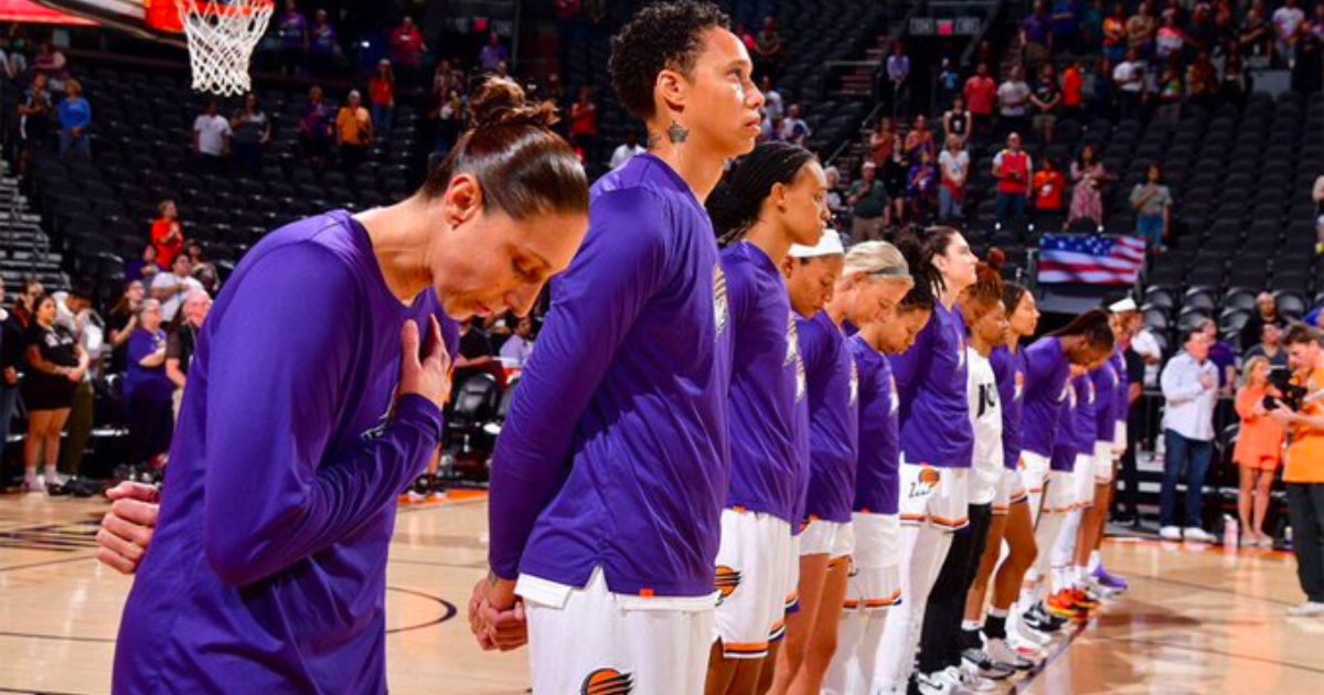 Brittney Griner of the Phoenix Mercury, center, stands for the national anthem before a preseason game against the Los Angeles Sparks in Phoenix on Friday.