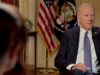 President Joe Biden gestures to a staffer who was trying to interrupt during an interview broadcast Friday with MSNBC's Stephanie Ruhle.