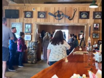 Patrons of the Rainbow Oaks Country Market in the Southern California town of Fallbrook stand for the national anthem.