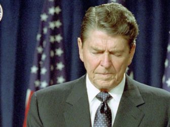 Former President Ronald Reagan is seen praying.