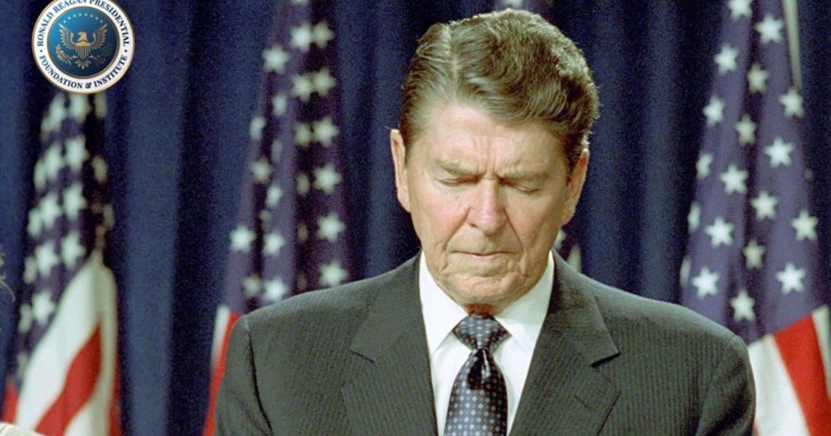 Former President Ronald Reagan is seen praying.