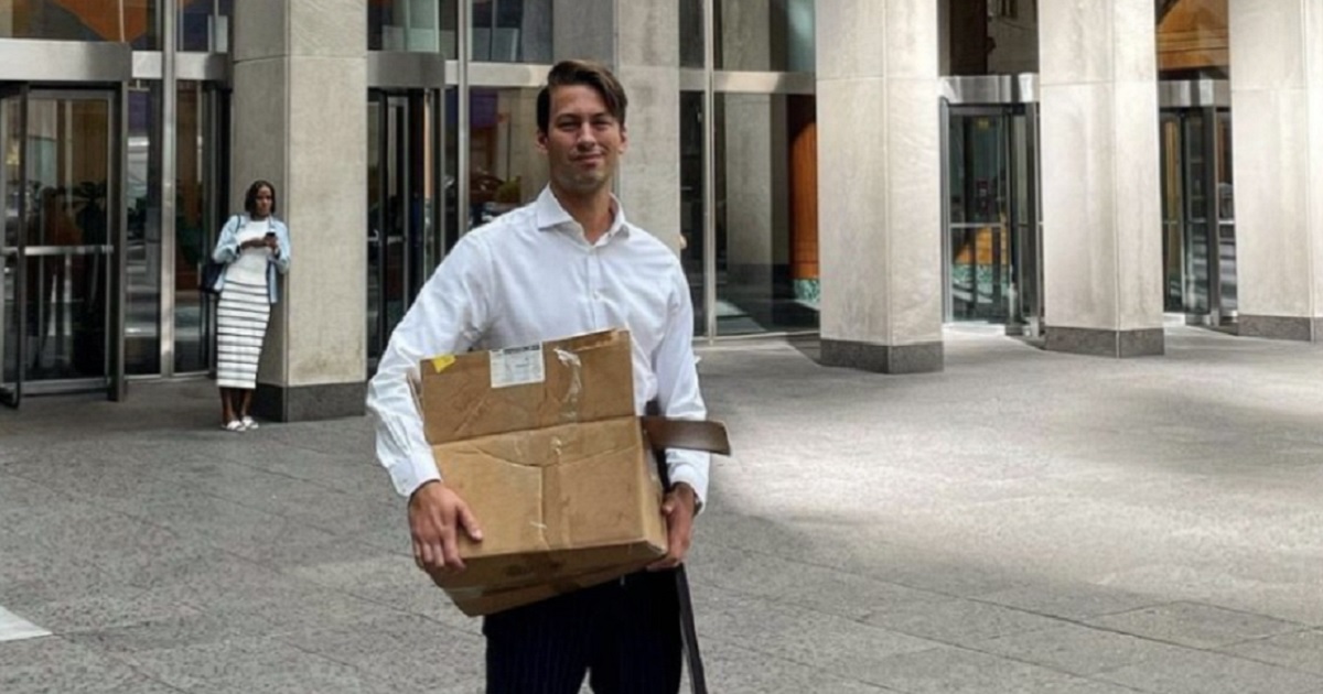 Former Fox News producer Alexander McCaskill carries a box with his personal belongings after his departure from the network.