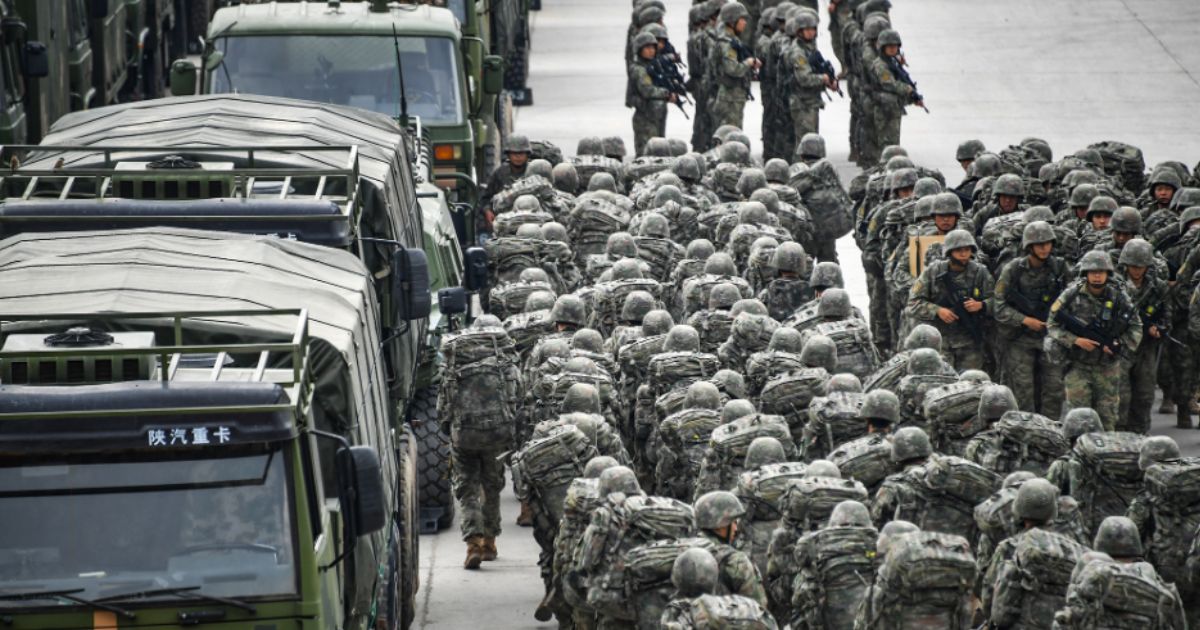 Troops assigned to a brigade under the Chinese People's Liberation Army 73rd Group muster in emergency to set out for the designated real-combat training field on Nov. 21, 2022.