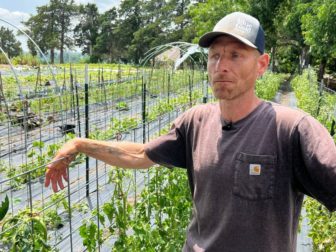 Michael Ruzycki talks to a reporter on his two-acre vegetable farm in Jones, Oklahoma.