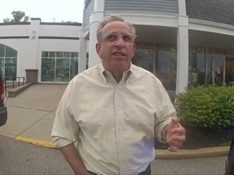 Rhode Island Senator Joshua Miller talks to police about keying the car of a Trump supporter in Cranston, Rhode Island, on Thursday.