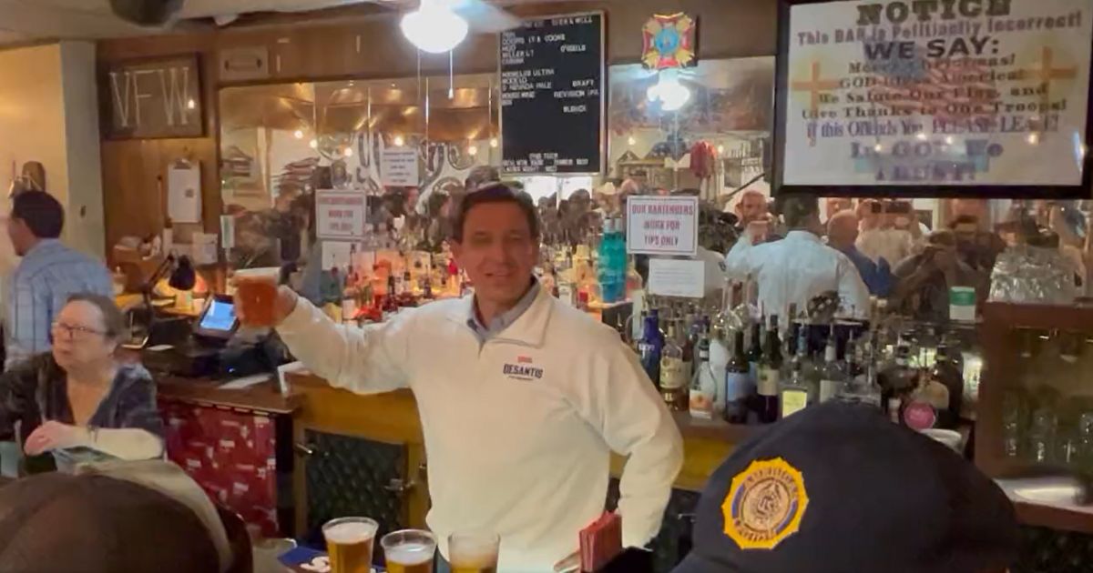 Florida Gov. Ron DeSantis serves beer to patrons at "The Bunker" VFW Post 9211 before the Reno Rodeo in Nevada on Friday.