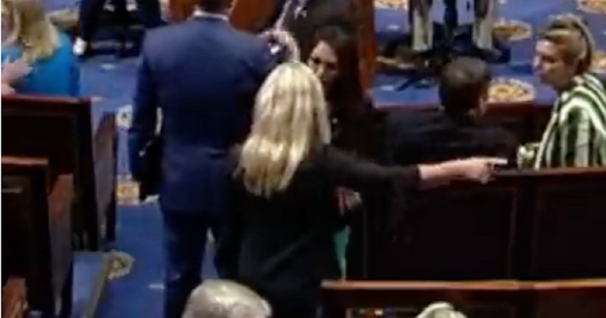 Reps. Marjorite Taylor Greene and Lauren Boebert appear to argue on the House floor in a C-SPAN video on Wednesday.