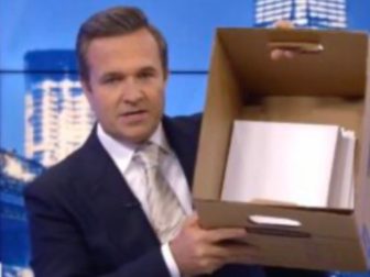 Newsman host Greg Kelly holds up a box to show the number of documents former President Donald allegedly did not declassify.