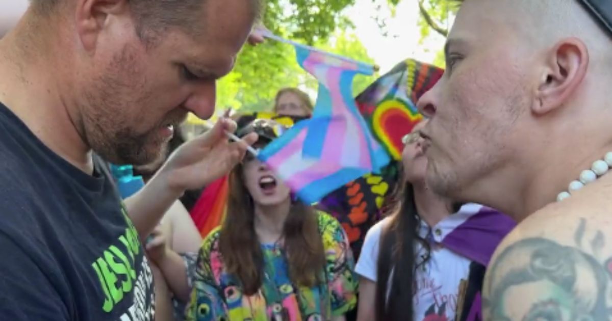 Attendees of a "pride" fest surround a street preacher in Seattle.