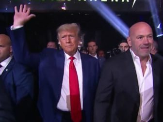 Former President Donald Trump, middle, arrives at UFC 290 with UFC President Dana White, right, at T-Mobile Arena in Las Vegas on Saturday.