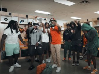 In a screenshot from the music video "Send A Blitz," rapper Real Boston Richey may have just cost numerous players scholarships and their football careers in his latest video.