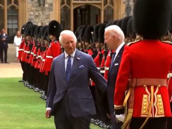 King Charles III, left, and President Joe Biden, right, inspect the Honor Guard after Biden arrives at Windsor Castle on Monday.