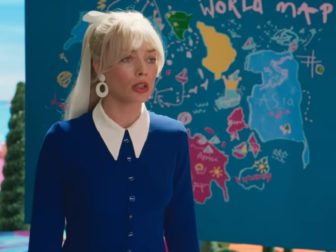 Margot Robbie, as "Barbie," stands in front of a crude world map. Dashes on the map have provoked controversy.