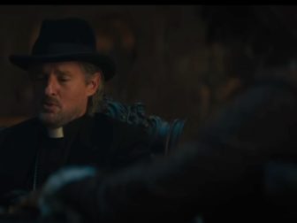 In this screenshot from the new “Haunted Mansion” trailer, Owen Wilson, who plays Father Kent in the movie, is seen in conversation with another character.