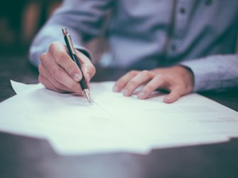 man writing on paper, science, research