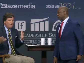 South Carolina Sen. Tim Scott speaks with host Tucker Carlson on Friday during a forum.