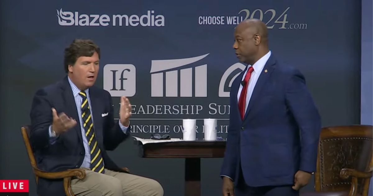 South Carolina Sen. Tim Scott speaks with host Tucker Carlson on Friday during a forum.