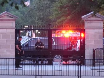 HAZMAT crews are pictured behind the gates on West Executive outside the entrance to the West Wing in Washington D.C., on Sunday.