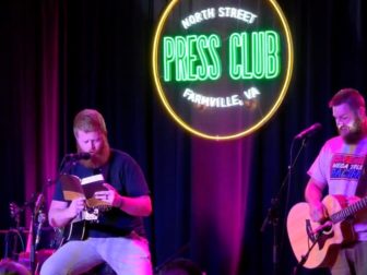 Oliver Anthony reads the Bible during a show in Farmville, Virginia.