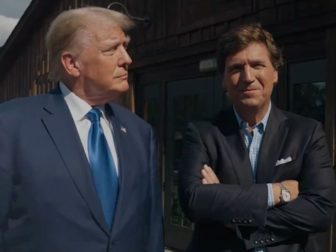 Former President Donald Trump stands with Tucker Carlson before their interview on X.