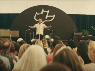 In this frame of "Jesus Revolution," actor Kelsey Grammer, who plays Pastor Chuck Smith, is seen preaching.