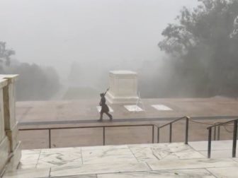 In a post from Sunday, a soldier watches over the Tomb of the Unknown Soldier, despite 60-85 mph wind and rain. (@pneaville / Twitter screen shot)