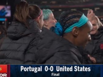 Controversial soccer player Megan Rapinoe (blue hair) dances with fellow members of the U.S. Women's National Team after a tie game in New Zealand in the Women's World Cup.