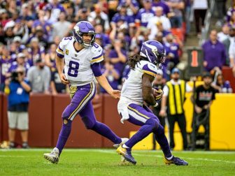 Kirk Cousins, quarterback with the Minnesota Vikings hands the ball off to running back Dalvin Cook during a game against the Washington Commanders at FedEx Field in Landover, Maryland on November 6, 2022.