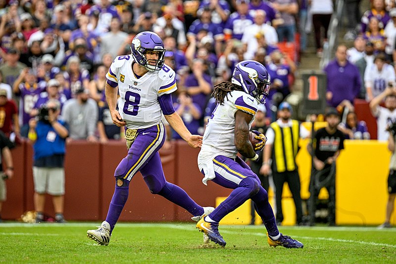 Kirk Cousins, quarterback with the Minnesota Vikings hands the ball off to running back Dalvin Cook during a game against the Washington Commanders at FedEx Field in Landover, Maryland on November 6, 2022.