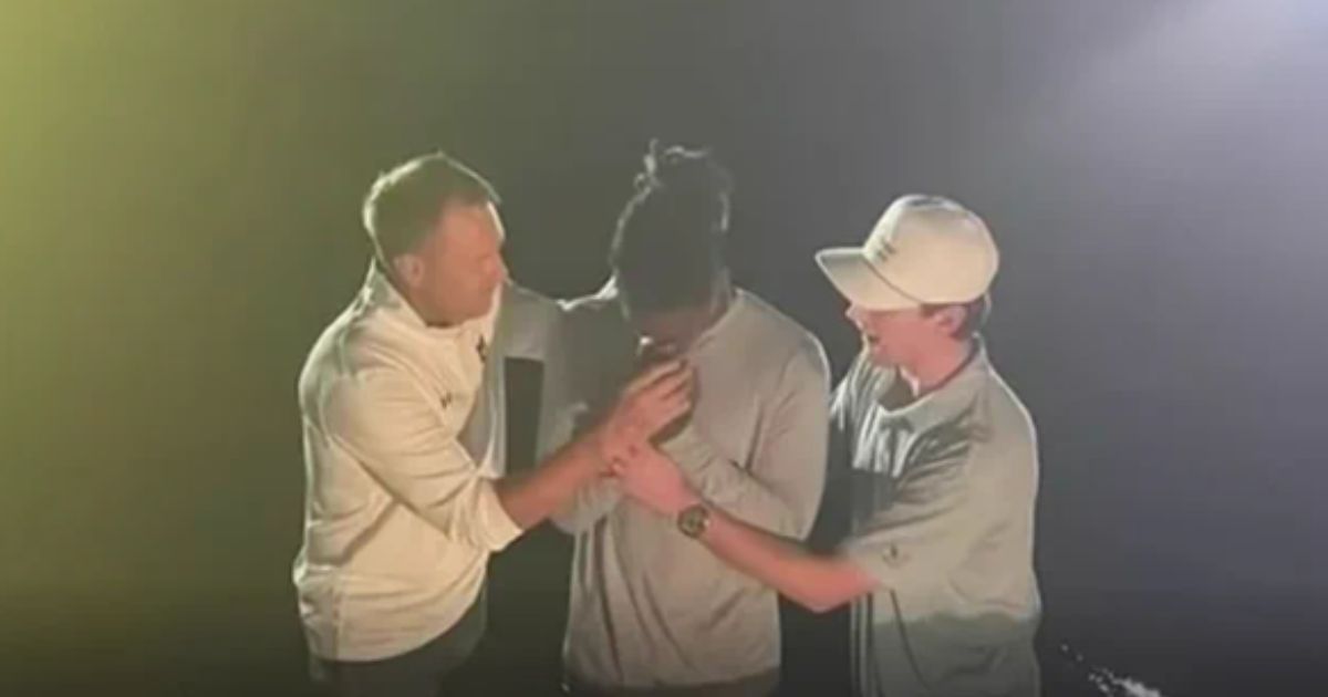 Someone is seen getting baptized at Auburn University.