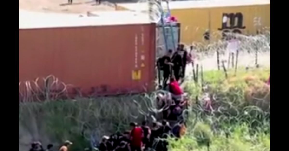 Migrants are seen at the border.