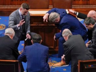 Newly elected Speaker of the House Mike Johnson joined other congressmen for a prayer on the House floor in January.