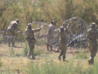 Texas National Guard troops erect razor-wire barriers near the state border with New Mexico.