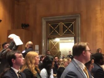 A protester is removed during the Senate Foreign Relations Committee nomination hearing.