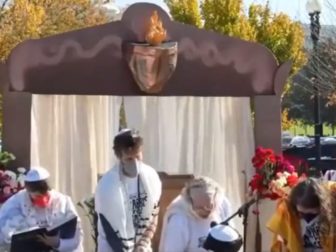 A woman reads from the Torah during a Rabbis for Ceasefire event in Washington on Nov. 13.